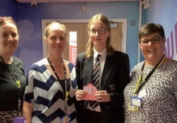 Photo image of the winning student receiving her voucher 