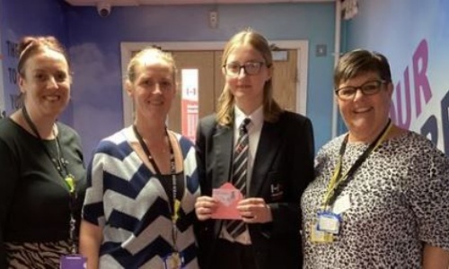 Photo image of the winning student receiving her voucher 